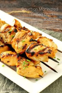 Bourbon marinated grilled chicken kabobs on white plate