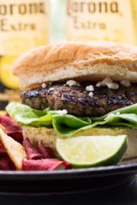 Carne asada mexican burger with a lime and chips