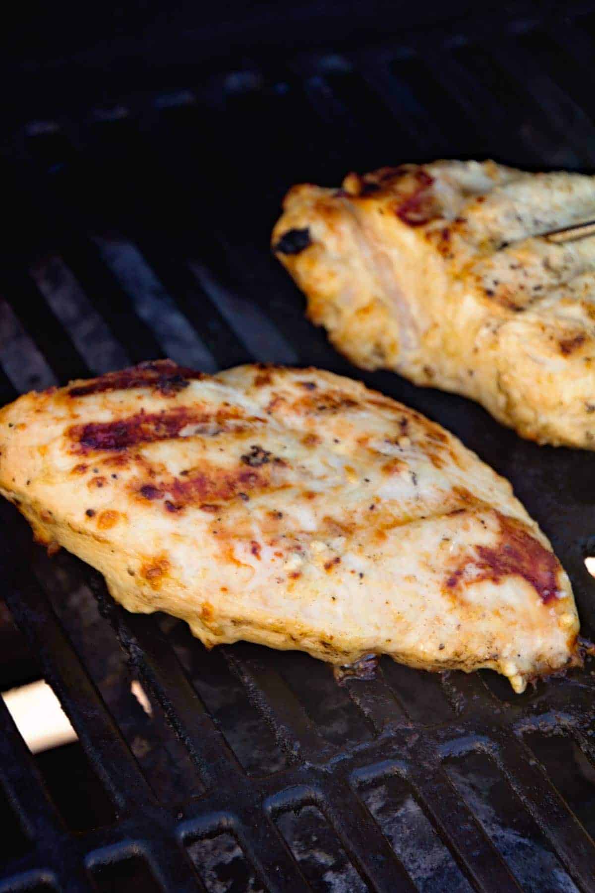Grilled Caesar Chicken breasts on grill