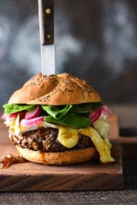 Cheese board burger with knife in the middle