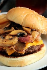 Cheese stuffed bacon burger topped with mushrooms