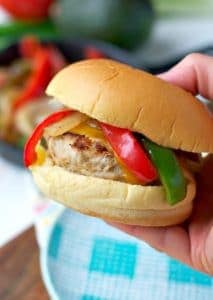 Hand holding chicken fajita burger