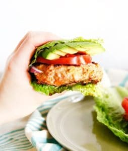 Hand holding moroccan chicken burgers