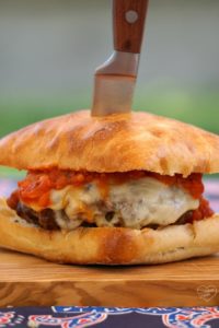 New York pizza burger with knife through the middle