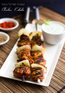 Spicy grilled tomato chicken kabobs on plate