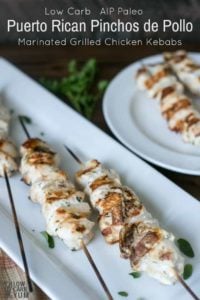 Marinated grilled chicken kebabs on white plate