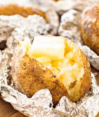 baked ptoatoes cut up with butter