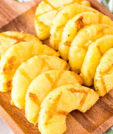 grilled pineapple slices on cutting board