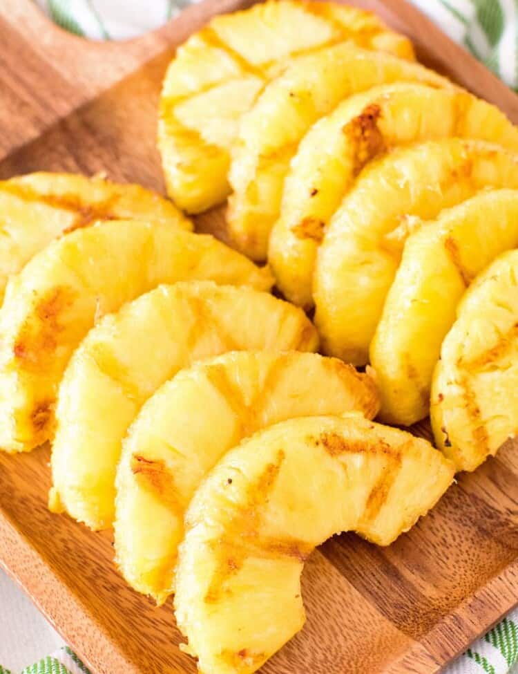 grilled pineapple slices on cutting board