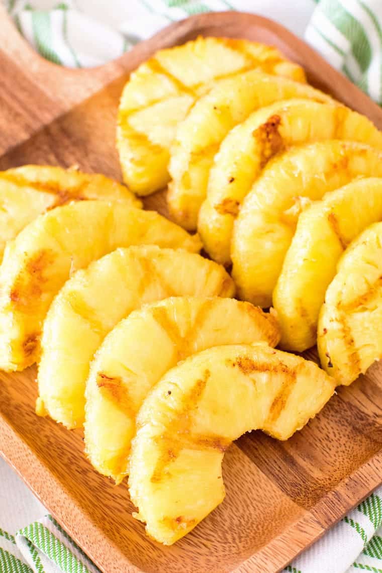 grilled pineapple slices on cutting board