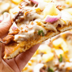 Slice of Pulled Pork Pizza in hand