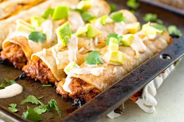 Pulled Pork Taquitos on sheet pan that have been baked