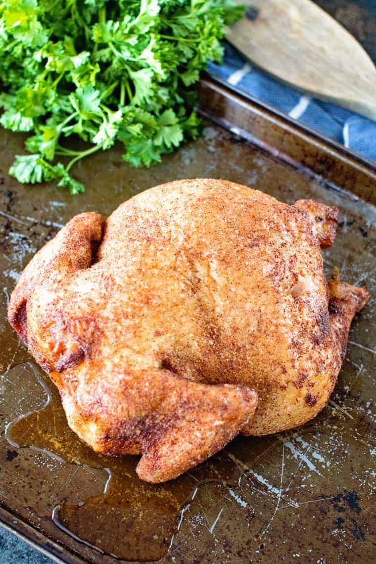 Whole smoked chicken on baking sheet