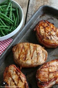 Grilled barbecue bacon pork chops on baking sheet