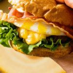 Burger with Fried Egg in hand