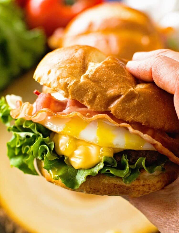 Hamburger with Fried Egg in Hand