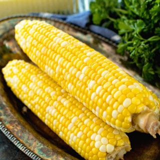 prepared grilled corn on the cob on a tray