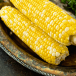 Stack of three Grilled Corn on the Cob on a tray