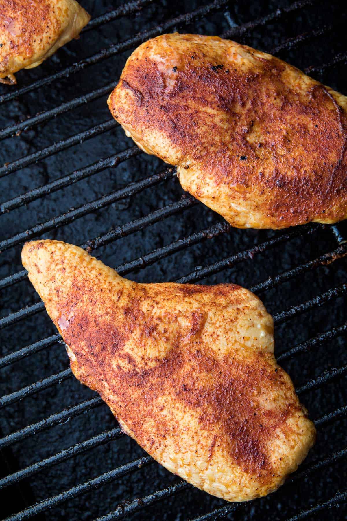 Seasoned chicken breasts on Traeger smoker