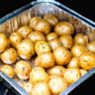 Potatoes in foil pan on smoker