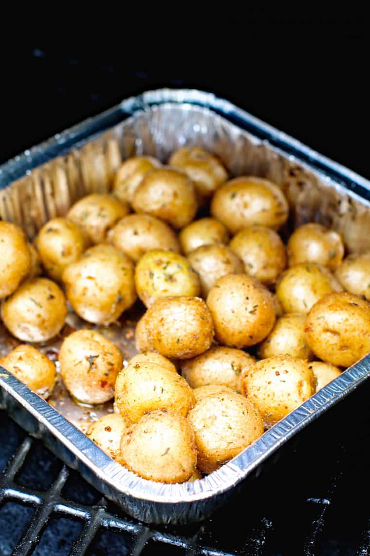 Potatoes in foil pan on smoker