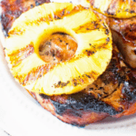 Grilled Pork Chops with Pineapple on white plate