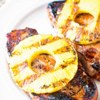 Grilled pineapple pork chops on a plate