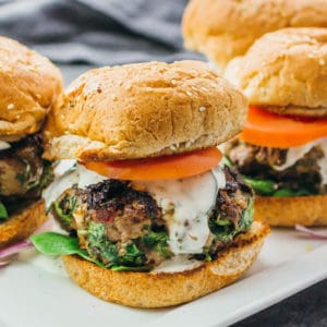 Greek burgers with feta, spinach, and tomato on plate