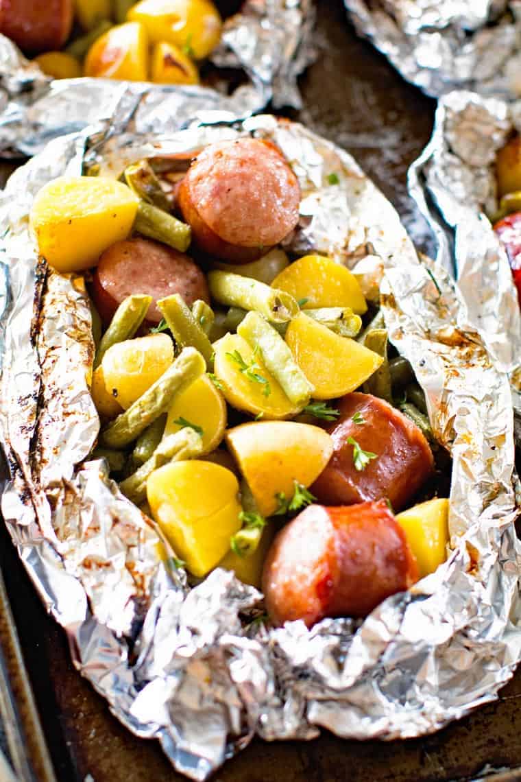 Grilled sausage foil packets filled with vegetables and sausage