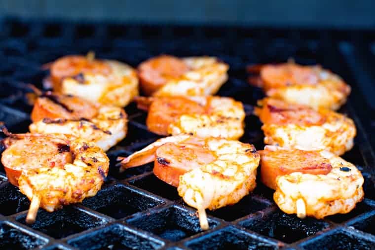 sausage and shrimp skewers on grill