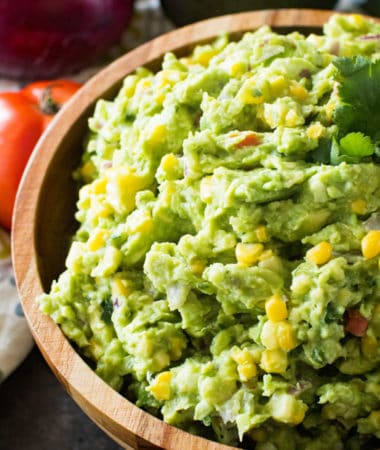 Corn guacamole in brown bowl