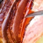 Spiral Ham Traeger being pulled apart with fork