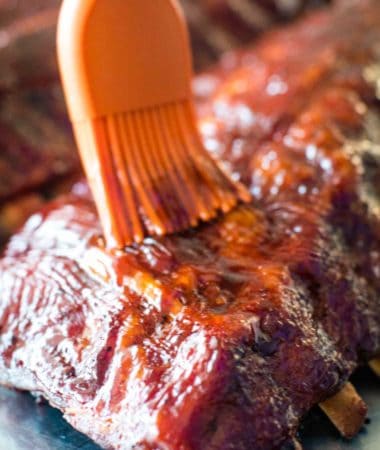 Easy Smoked Ribs being brushed with BBQ sauce