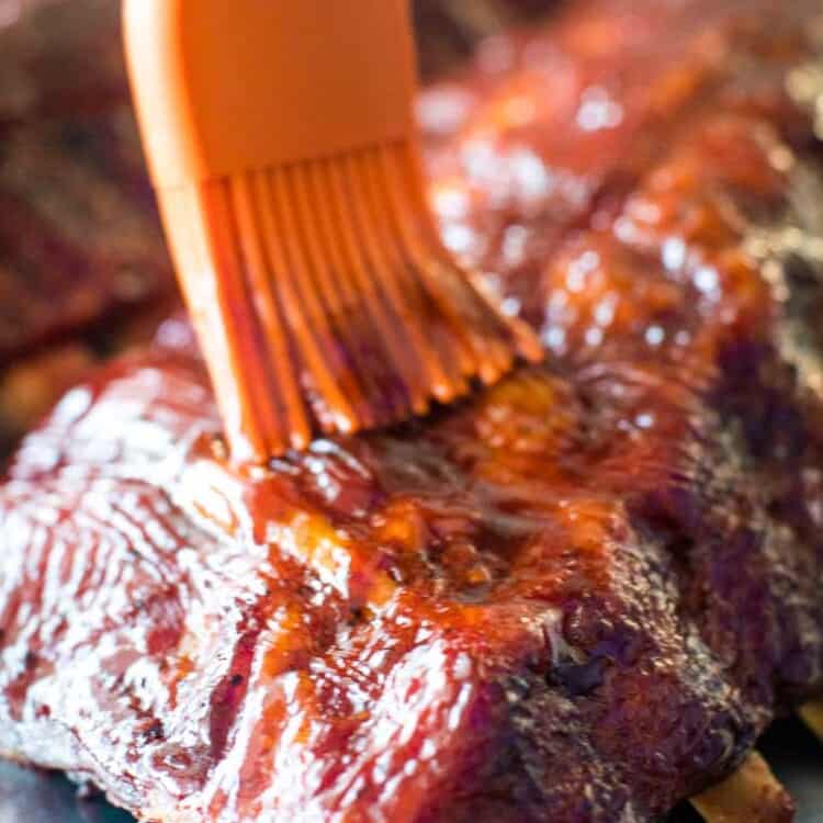 Easy Smoked Ribs being brushed with BBQ sauce