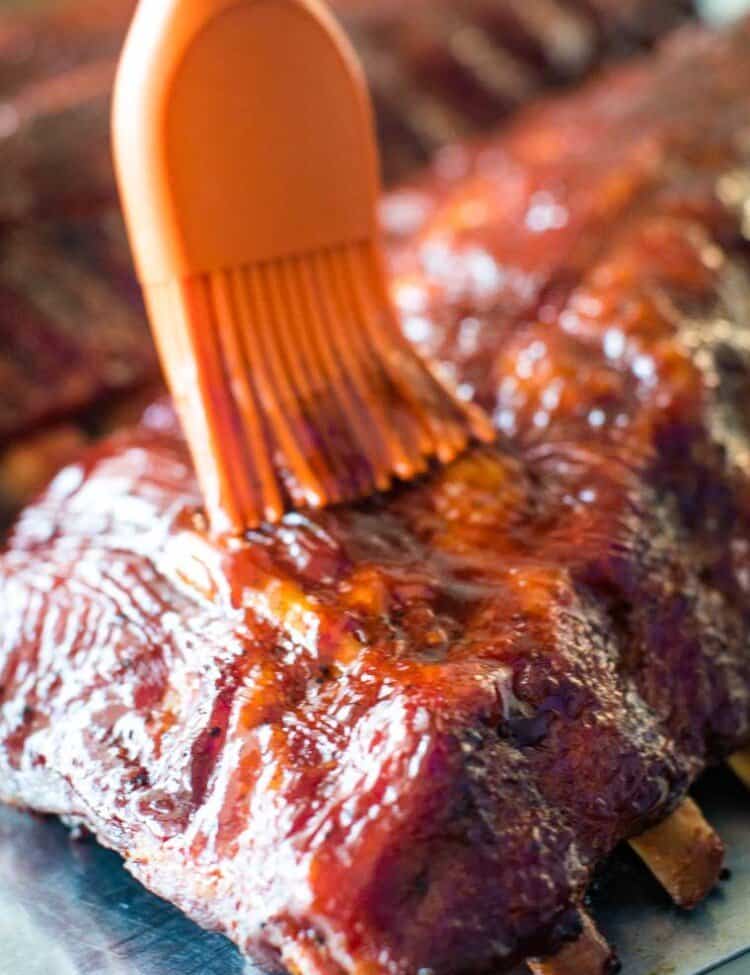 Easy Smoked Ribs being brushed with BBQ sauce