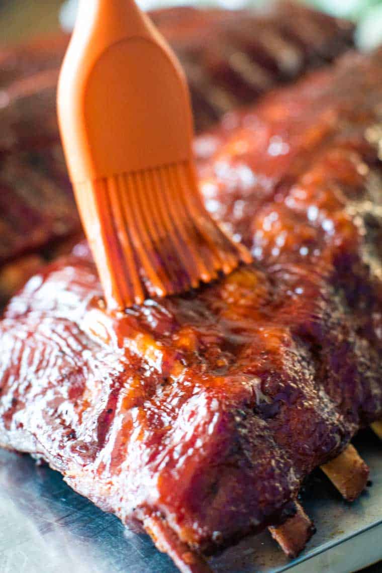 Easy Smoked Ribs being brushed with BBQ sauce