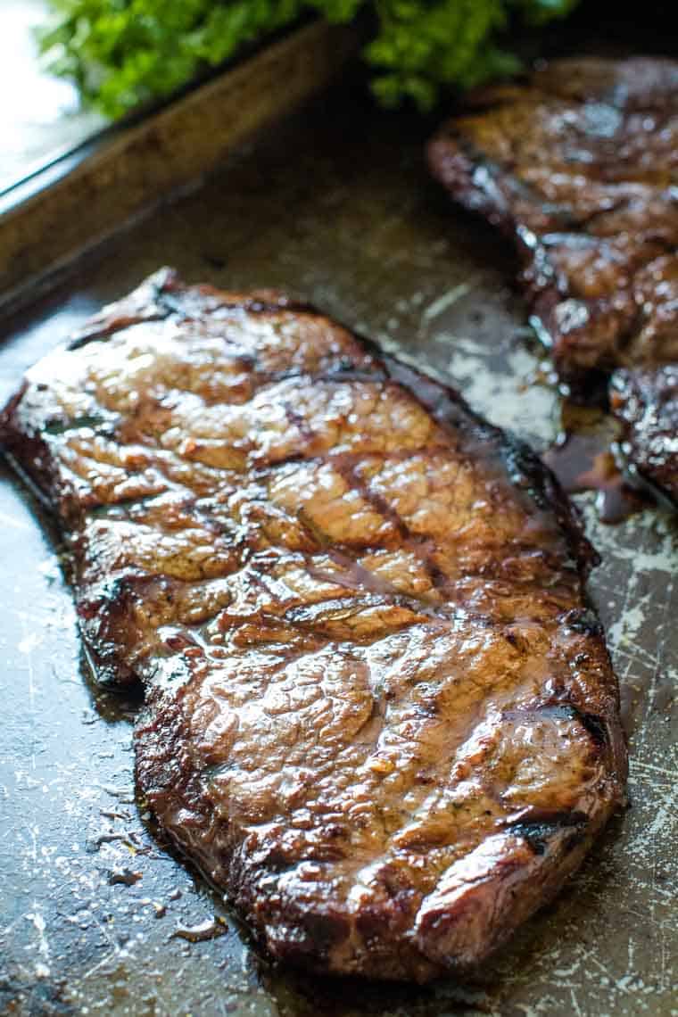 Grilled Bourbon Steak on a baking sheet