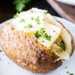 Smoked baked potato with butter on plate