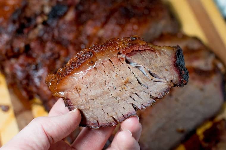 How to smoked a beef brisket in persons hand