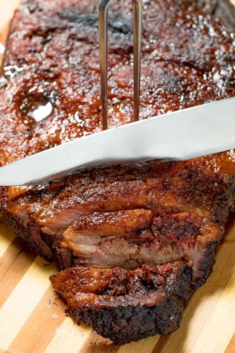 Smoked Brisket being cut with knife