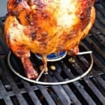 Beer can grilled chicken pinterest image. A whole chicken with a beer can on a stand.