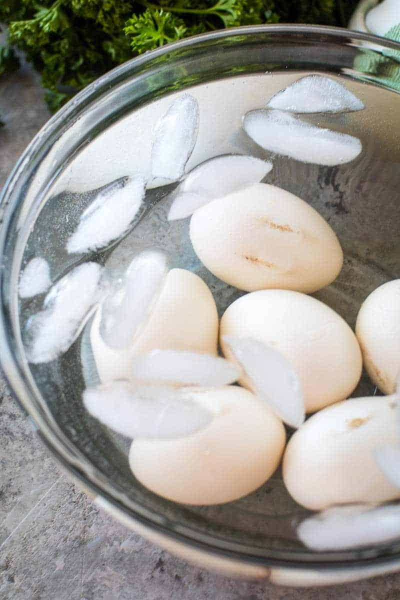 Glass bowl with eggs in ice water bath