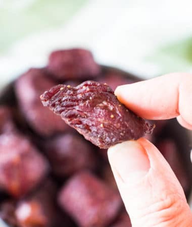hand holding teriyaki smoked steak bites