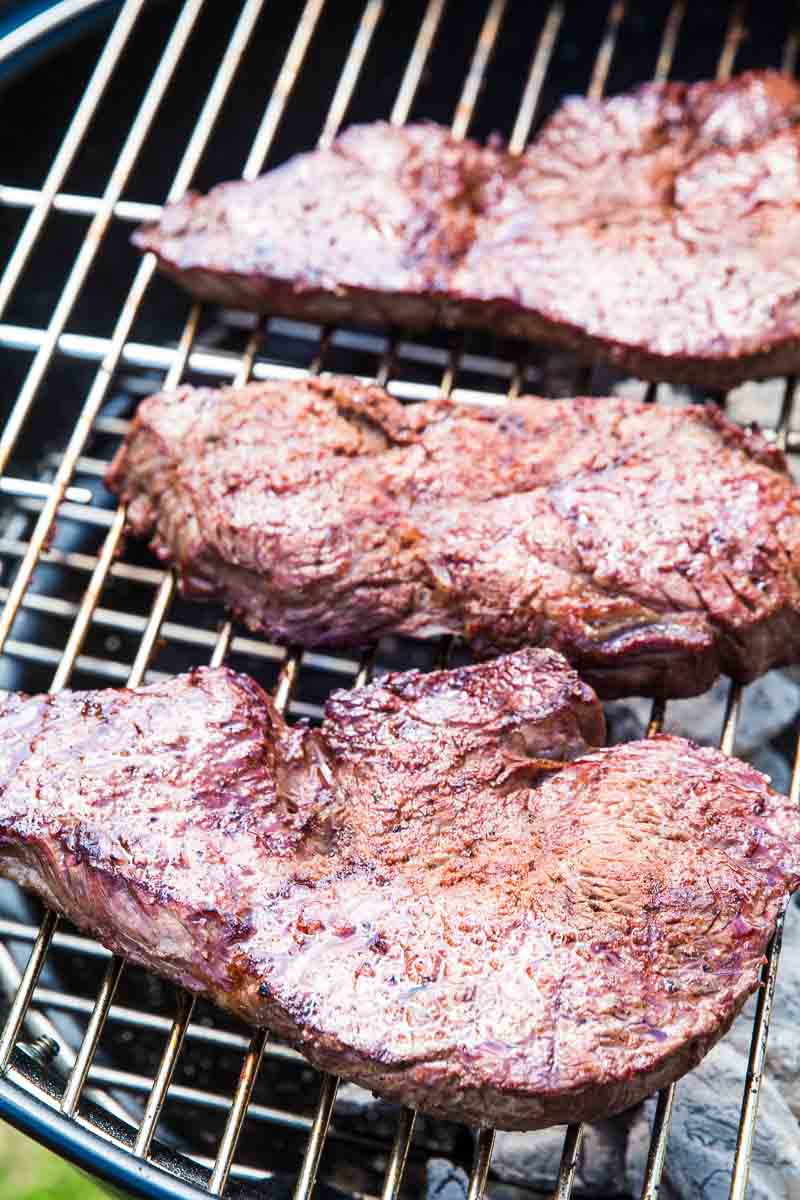 Steaks on charcoal grill