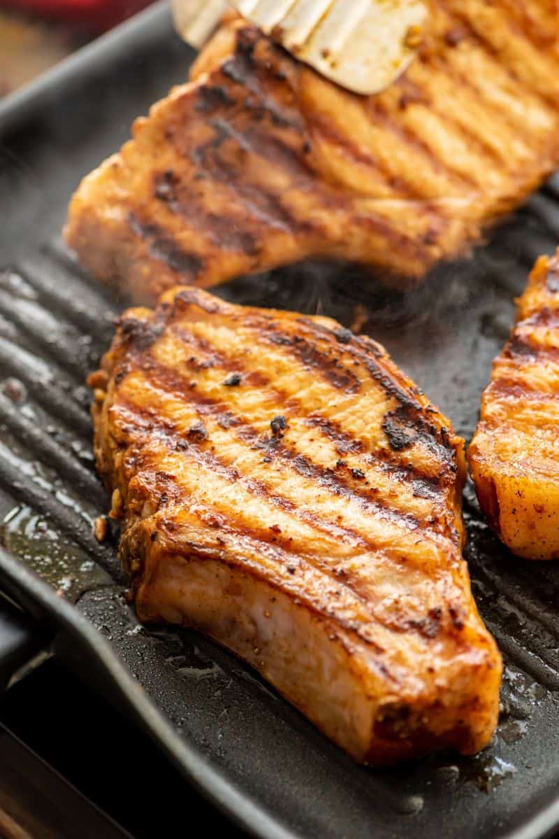Grill pan with bone-in pork chops on it