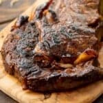 Grilled and marinated steak on wood cutting board
