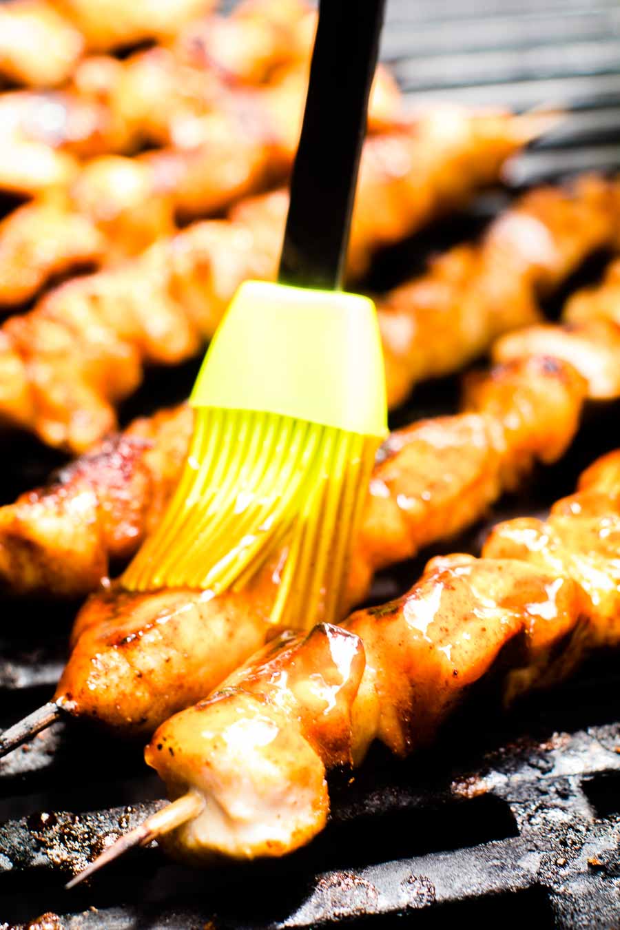 Chicken Kabobs being brushed with BBQ Sauce