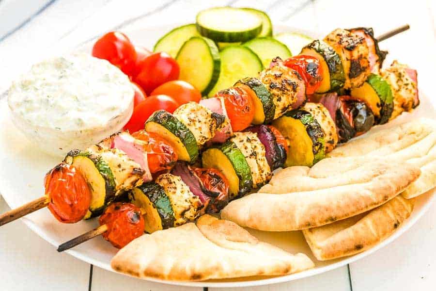 Greek Chicken Kabobs Recipe on plate with pita bread