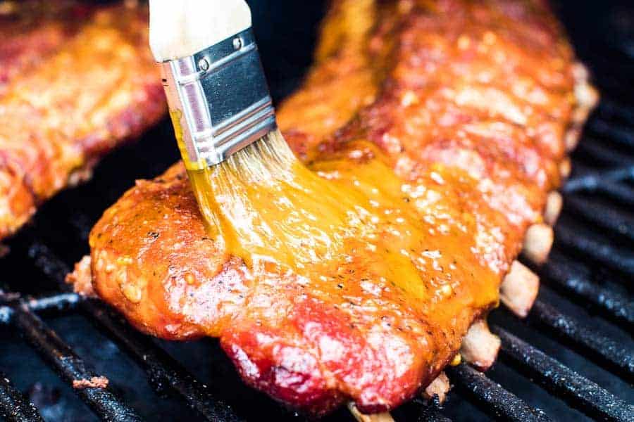 Smoked Ribs with honey mustard sauce being brushed on