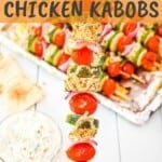 greek chicken kabob close up and white dip in a bowl